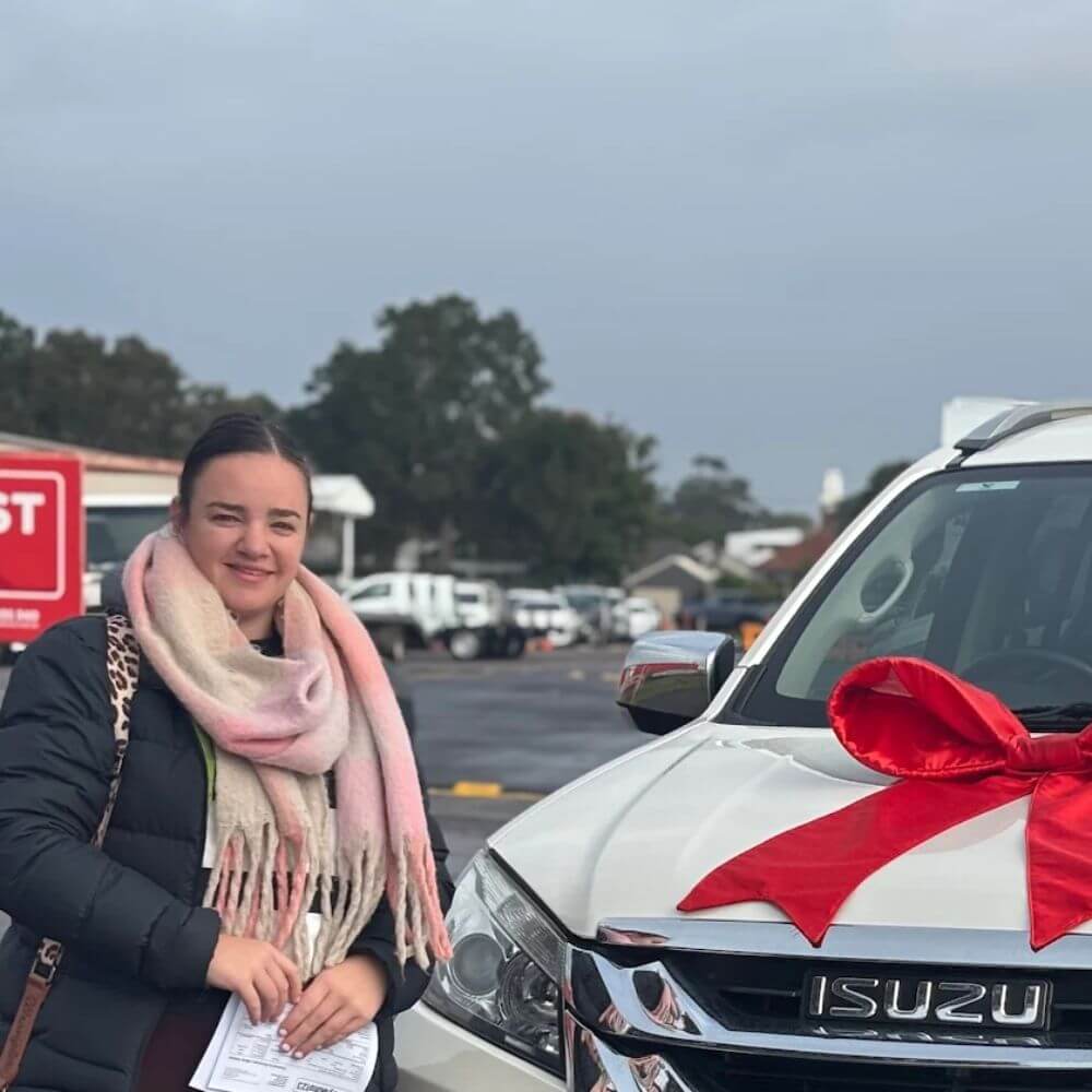 Paige in front of her new car